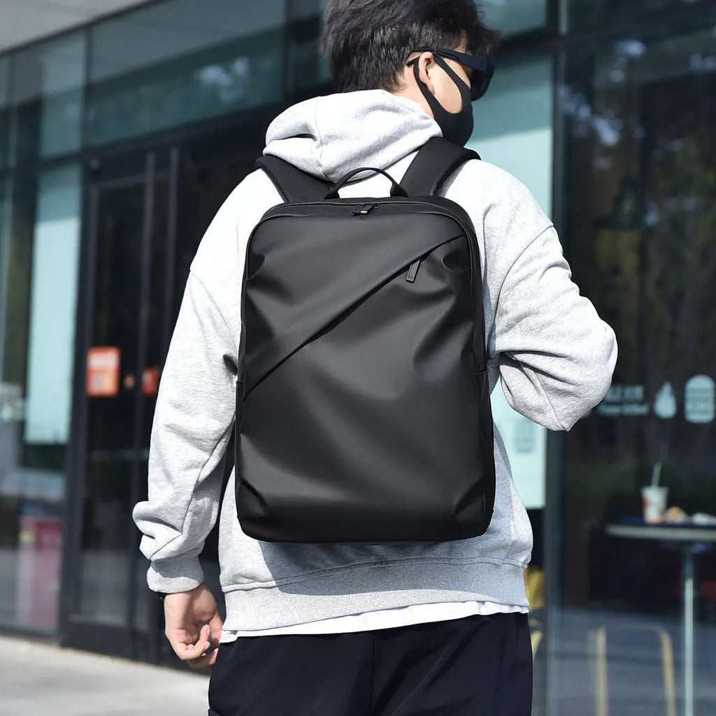 Waterproof PU leather backpack with sewing thread details in black, blue, and grey colour options