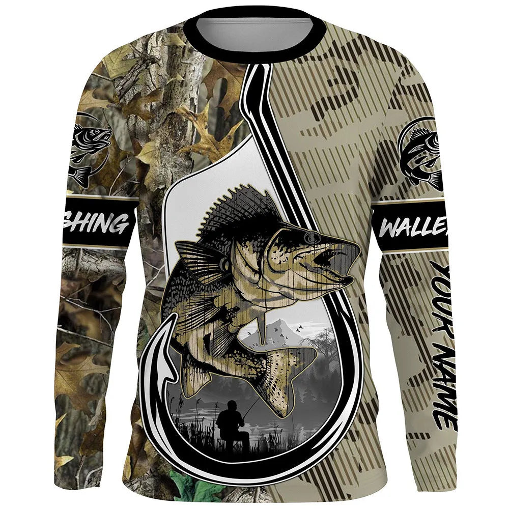 Man wearing a long sleeve grey pullover top with a printed fish design on the chest.