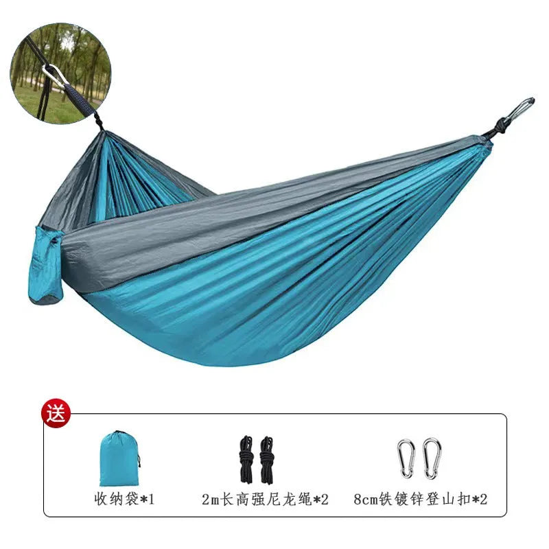 Blue nylon parachute cloth camping hammock hung between trees, showing its 270cm length.