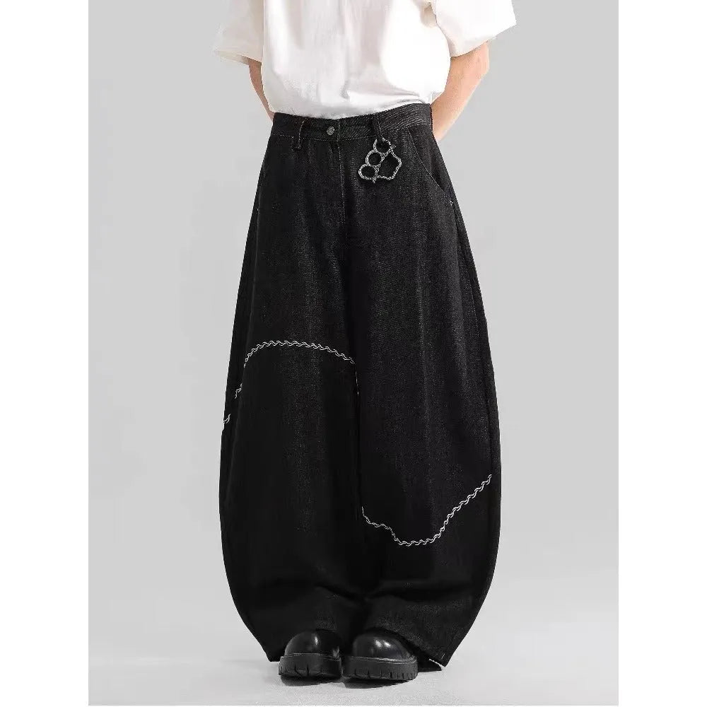 Black straight-leg denim trousers with mid-waist zip fly design on hanger