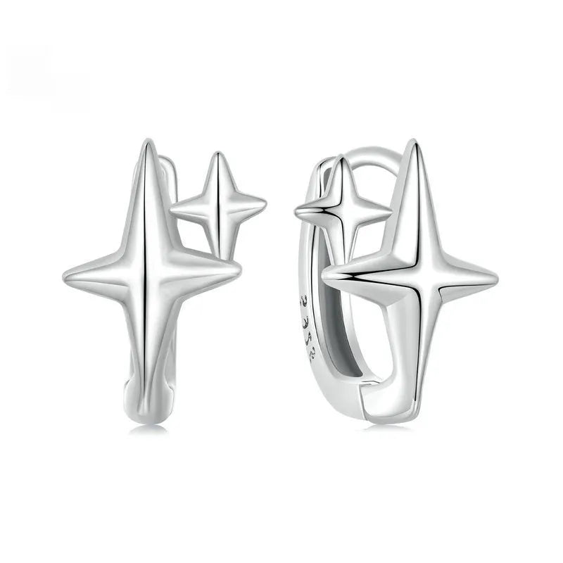 Sterling silver ear clips with minimalist star design and oxidation finish.