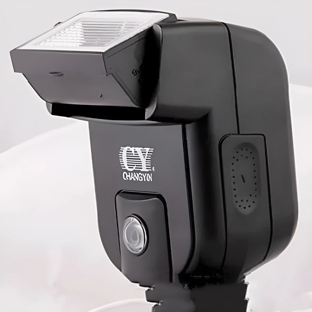 Silver hot shoe camera flash unit mounted on an SLR, shown with its head tilted upwards.