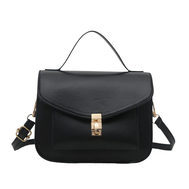 Horizontal square black PU messenger bag with a front sandwich pocket and visible sewing lines.