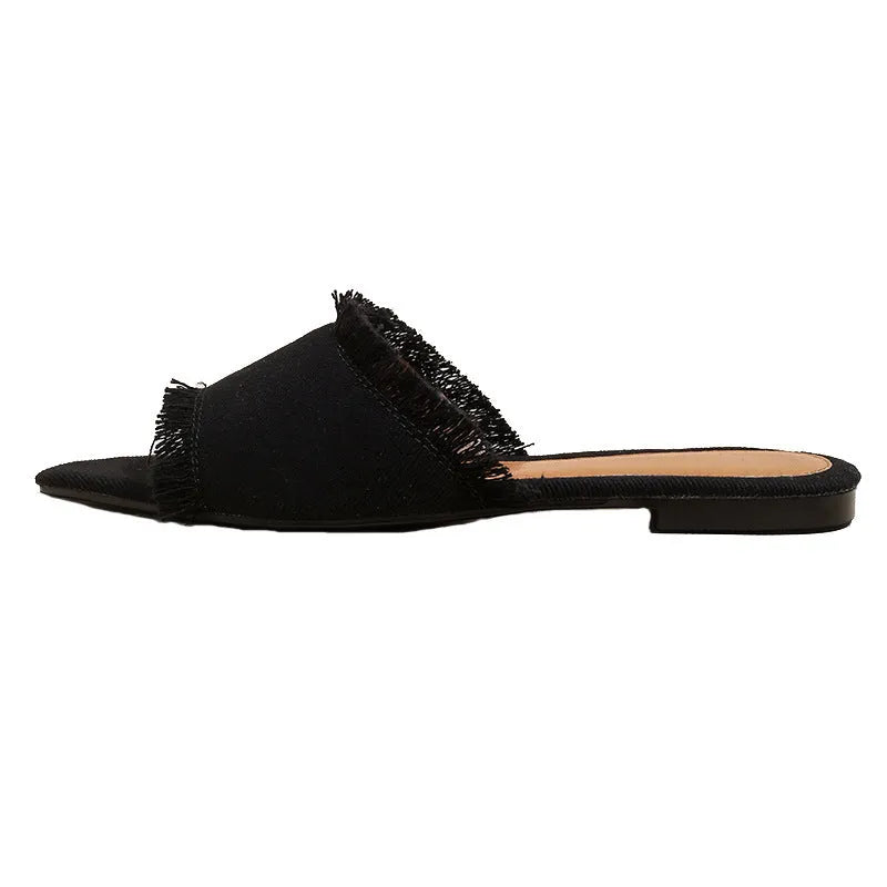Women's denim flat slippers with tassel detail in multiple colour options.