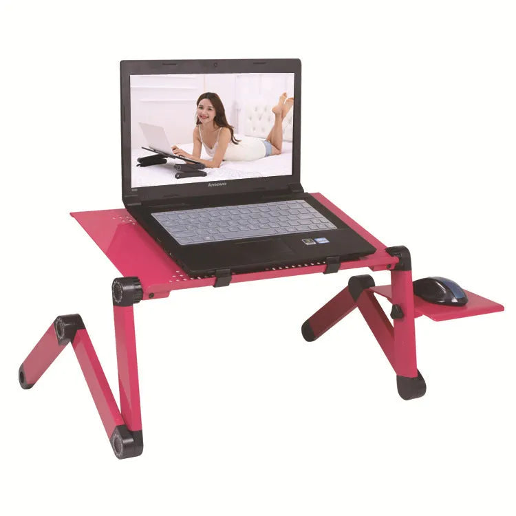 Black folding metal laptop desk with cooling holes extended over sofa