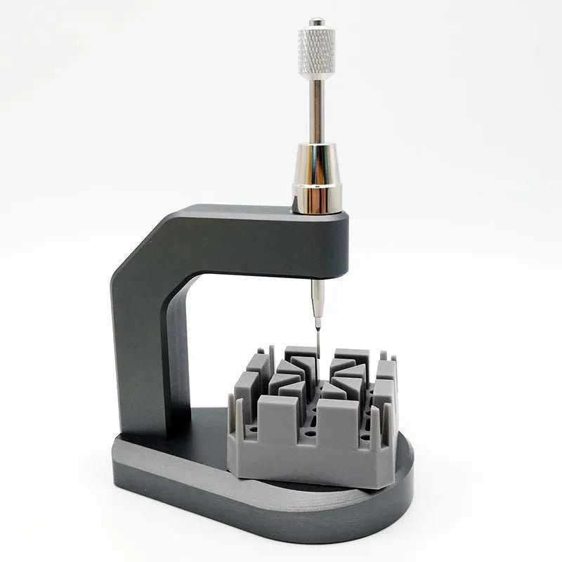 Silver tool steel press strap removal tool with 0.50-1.60mm blade specification on a work surface.