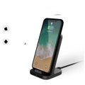 Dark grey vertical wireless charging stand for Apple iPhone on desktop