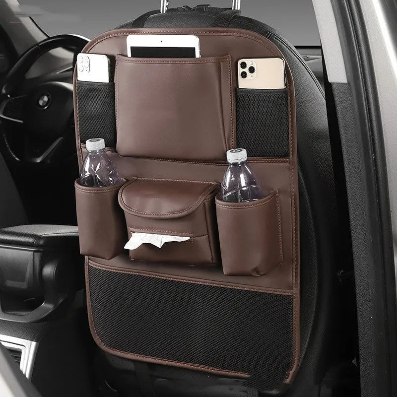 A leather car seat back storage bag hanging behind a vehicle seat.