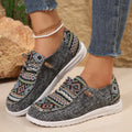 Women's flat slip-on shoes in black with round toe and rubber sole on a white background