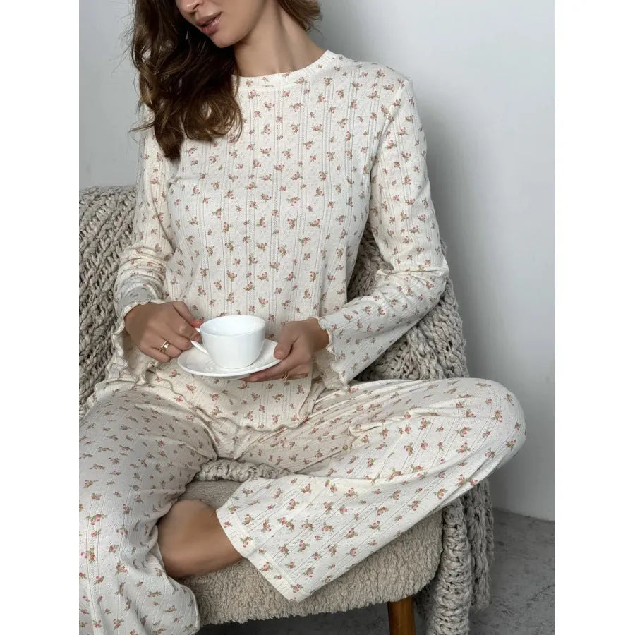 White floral print women's sleepwear set with long bell sleeve top and wide-leg trousers.