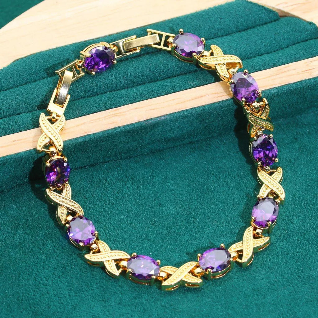 18k gold plated jewellery set with coloured cubic zirconia stones showing necklace, earrings, ring, and bracelet