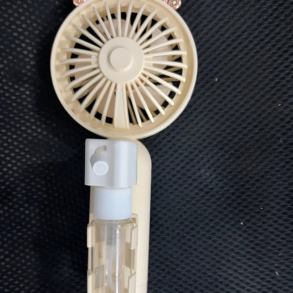 Plastic handheld nozzle fan with USB port in apricot, blue, green, orange, or pink colour.