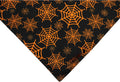 Black and orange reversible Halloween dog bandana with pumpkin and spider web patterns