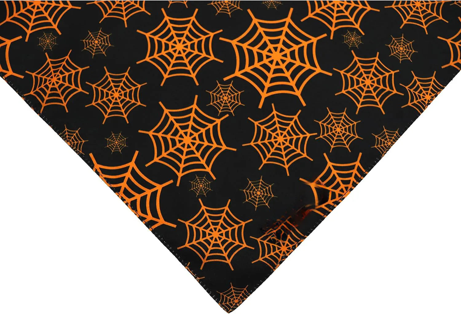 Black and orange reversible Halloween dog bandana with pumpkin and spider web patterns