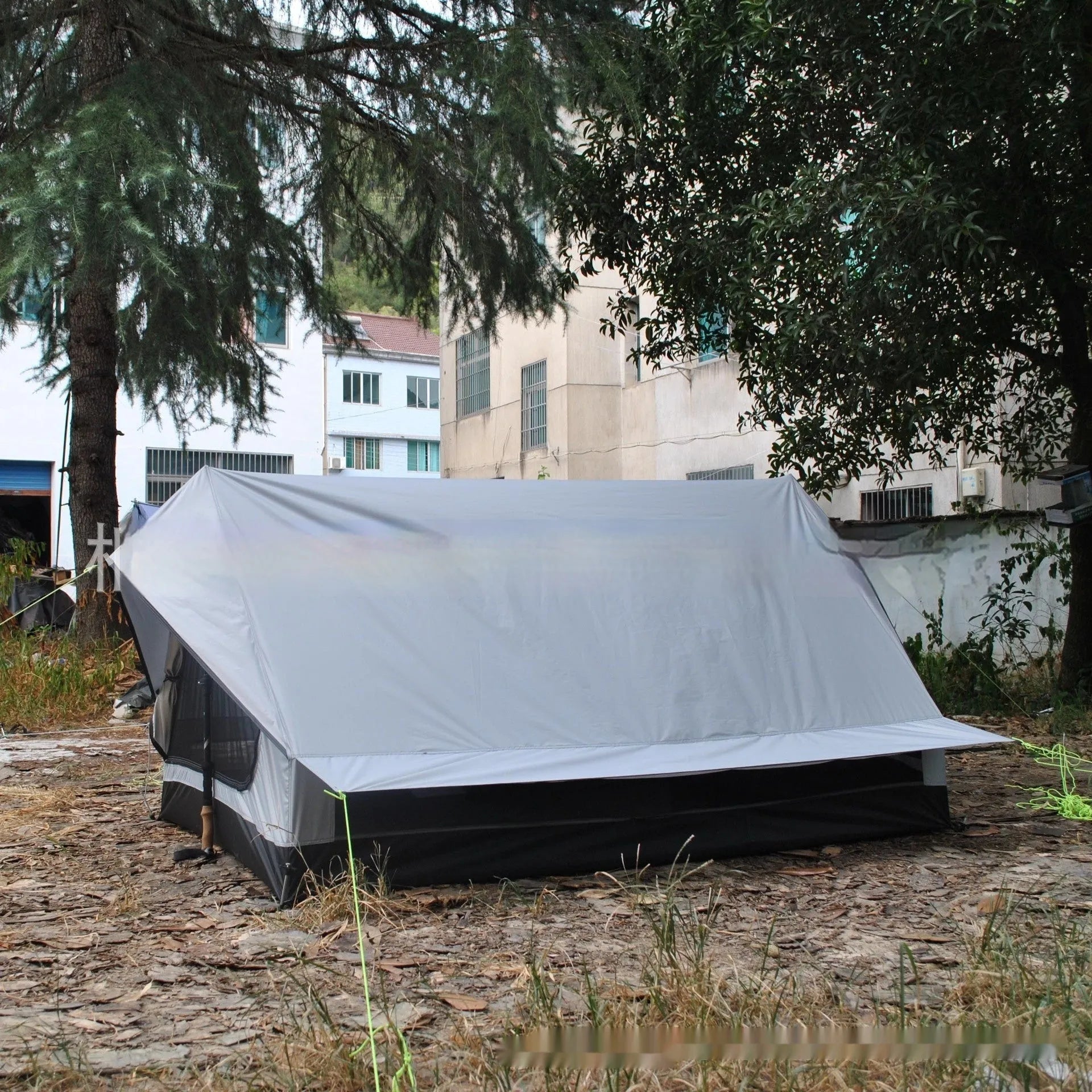 Brown A-line cabin tent setup with hiking pole supports showing spacious interior and waterproof fabric construction