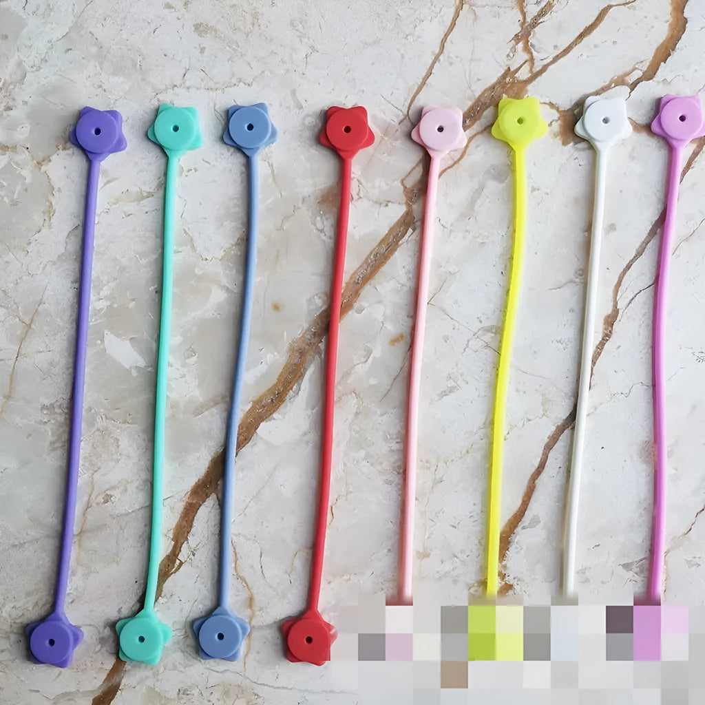Purple silicone wire winder with magnet for organising headphone and computer cables.