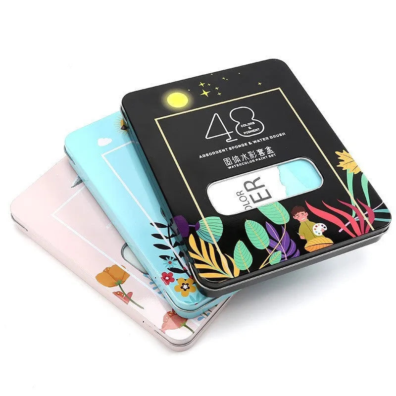 48 colour solid watercolour paint set showing compartmentalised layout with Black Knight, Girl Pink and Sunshine Blue shades