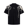 Black loose-fit short-sleeved T-shirt with padded shoulders and rivet ribbon detail.