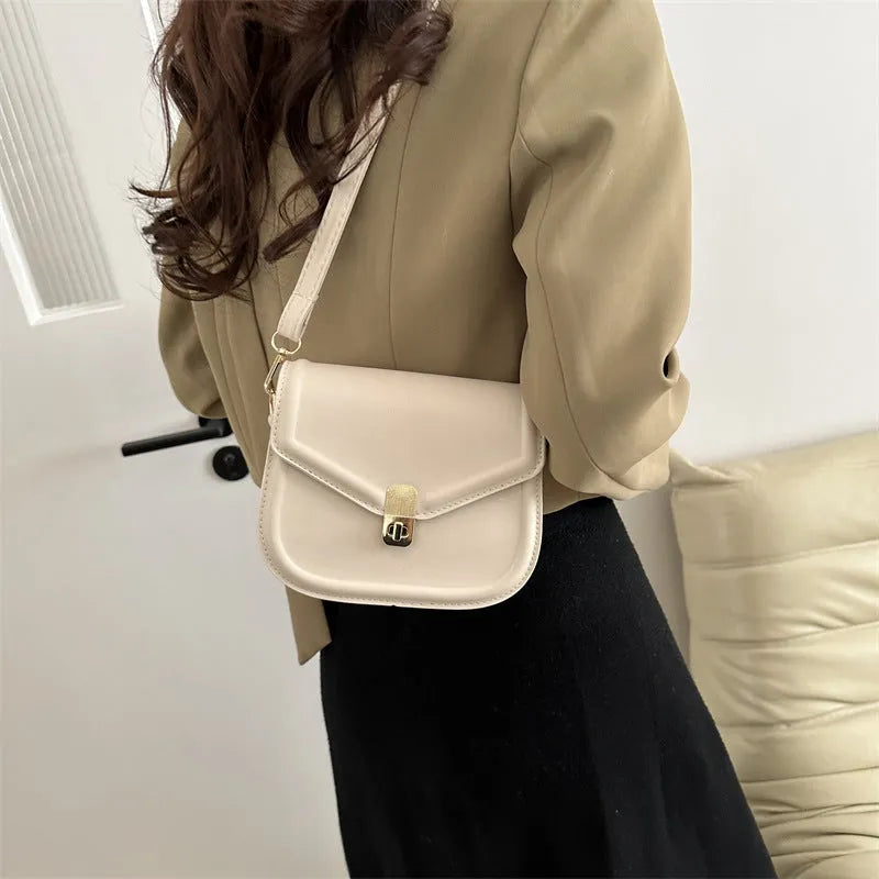 Soft PU messenger bag with textured finish and clamshell opening in horizontal square shape