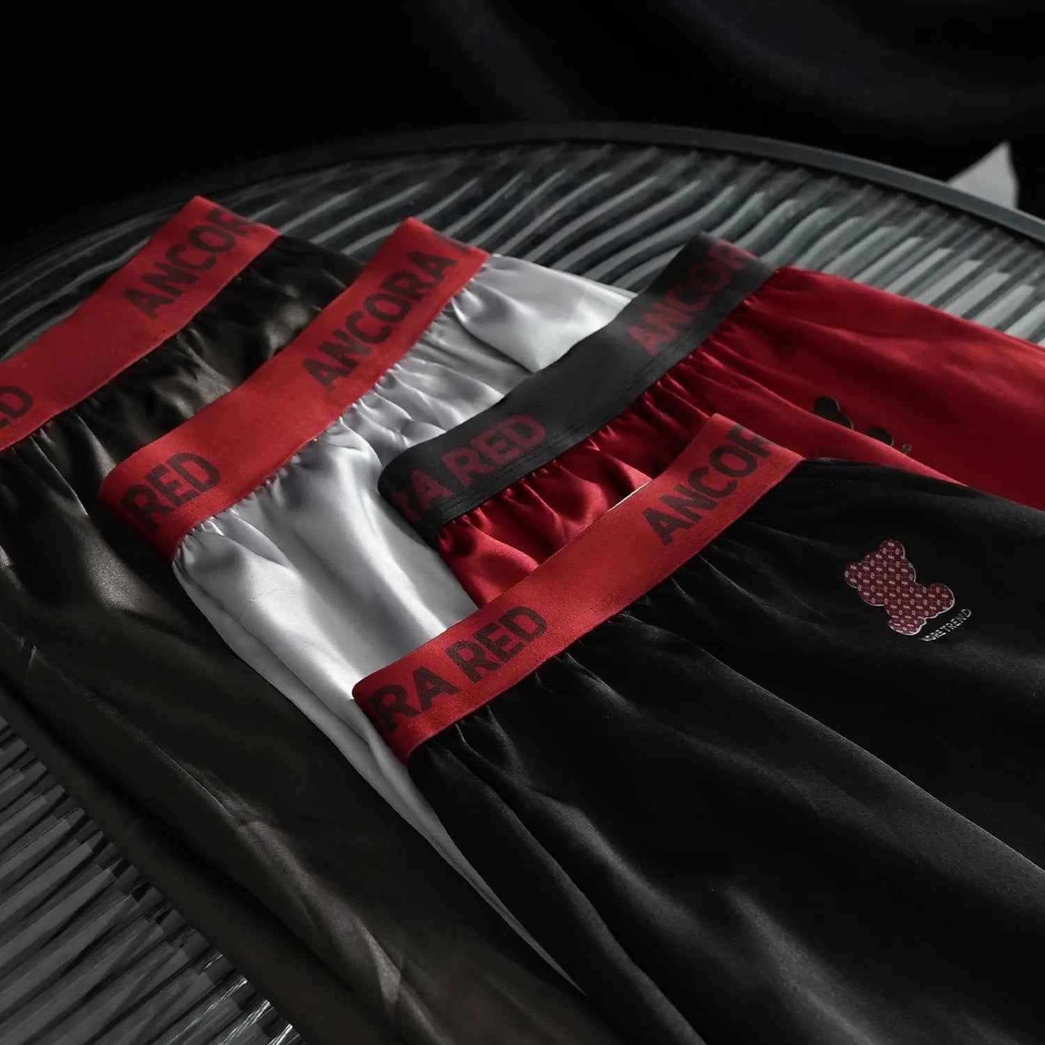 Solid colour men's boxer briefs in polyester knit fabric showing mid-waist design