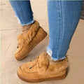 Women's white cotton house shoes with a round toe and a textured rubber non-slip sole.