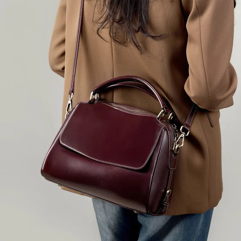 Women's genuine leather crossbody tote bag in apricot colour with double straps and outer slit pocket.