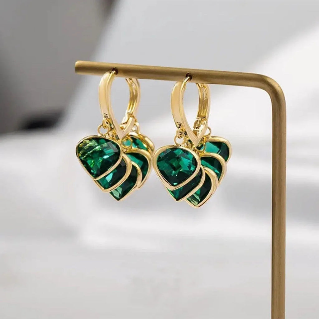 Pair of green heart-shaped glass pendant ear clip earrings with alloy and artificial gemstone details.