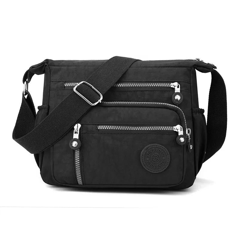 Soft nylon messenger bag in grey, shown as a square vertical model with a single shoulder strap.