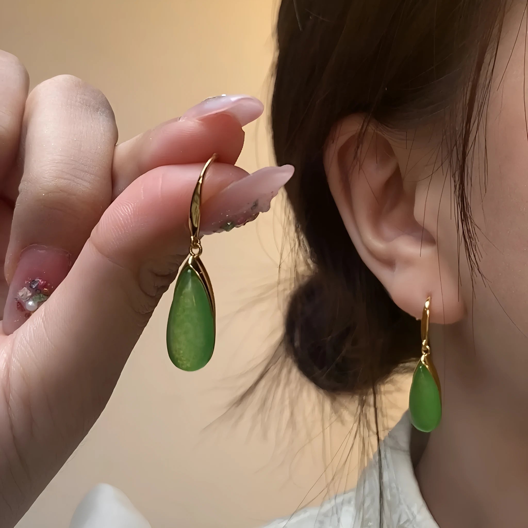 A pair of jade green retro Chinese-style geometric earrings with water droplet details.