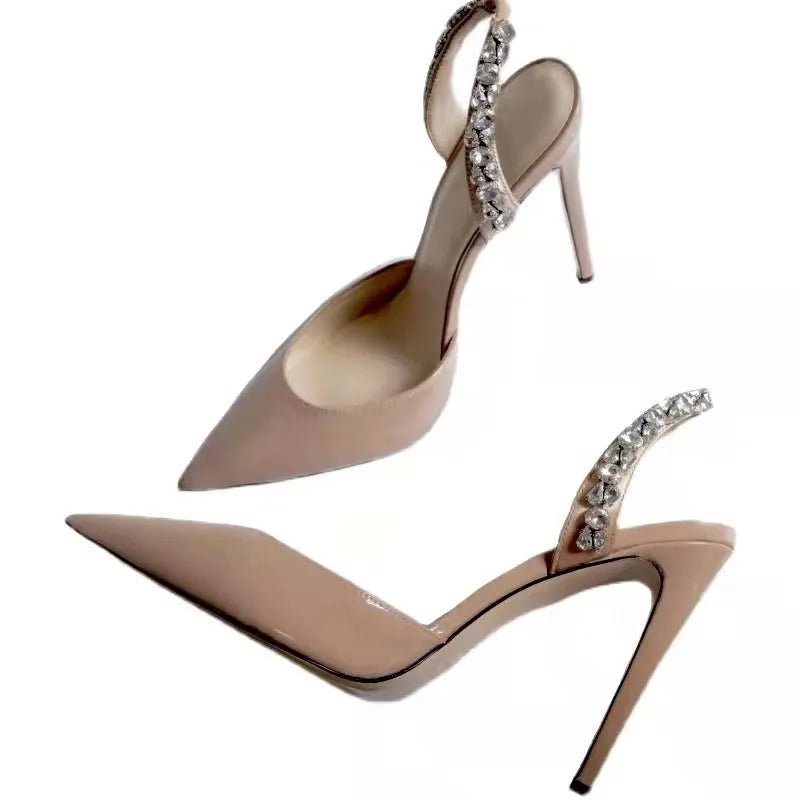 Black patent leather women's high heel sandals with pointed toes and side rhinestone straps.