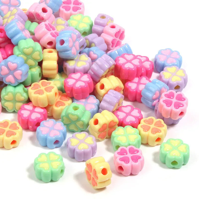 Assorted light-coloured acrylic clover-shaped beads with frosted finish, 15mm size.