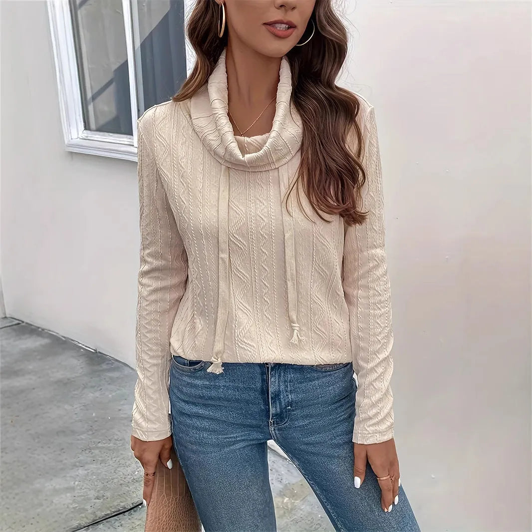 Apricot coloured hooded pullover sweater with long sleeves and a drawstring on the hood.