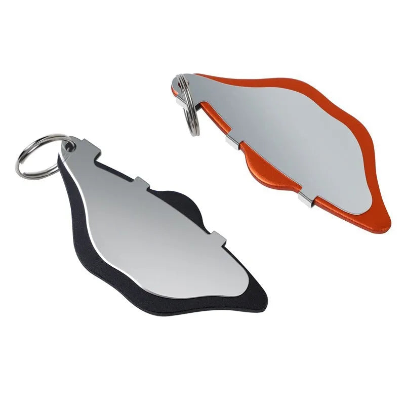 Black and orange metal mountain bike disc brake linings with adjustment flap on a neutral background.