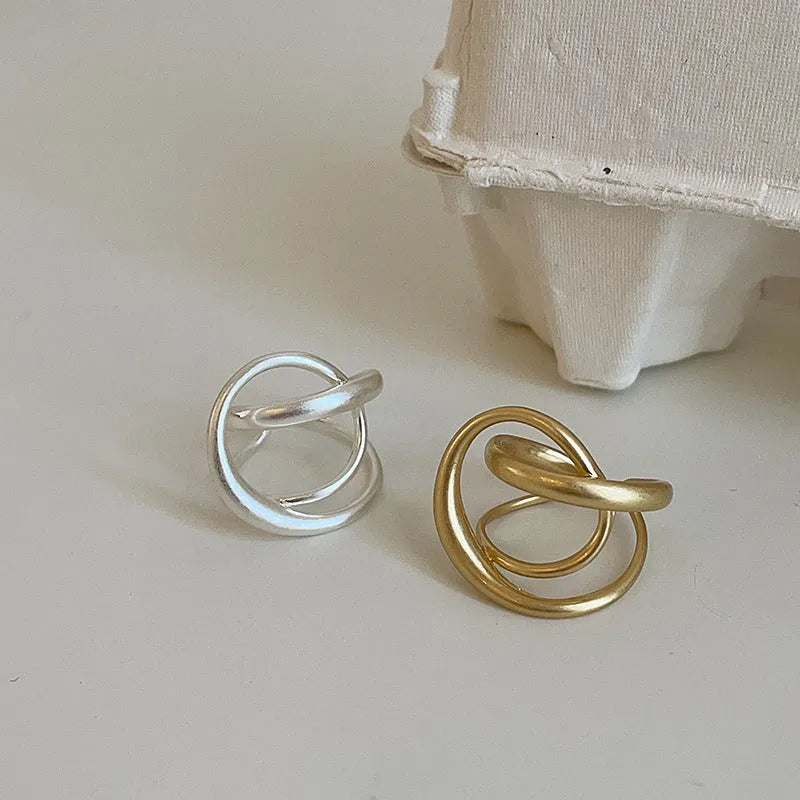 Geometric open ring with interlaced matte metal pattern in gold or silver electroplated finish