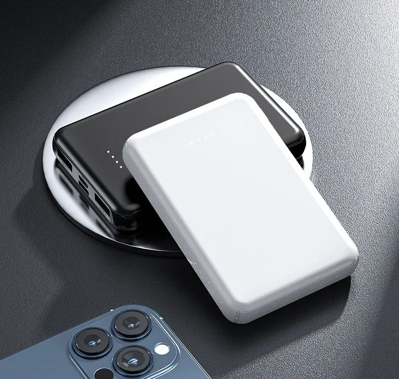 Black rectangular electric heating vest power bank with USB port, shown next to a measuring tape.