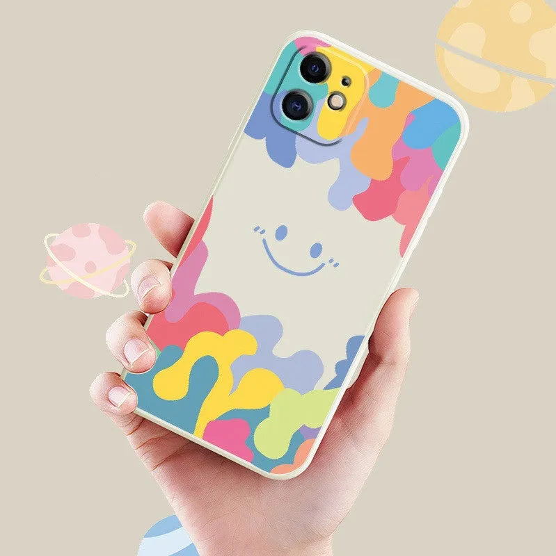 White TPU iPhone case with rainbow smiley faces on top and bottom, includes a black lanyard.