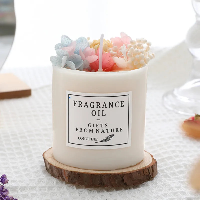 Aromatherapy candle with dried flowers embedded in wax, shown with optional wooden chip base and gift box.