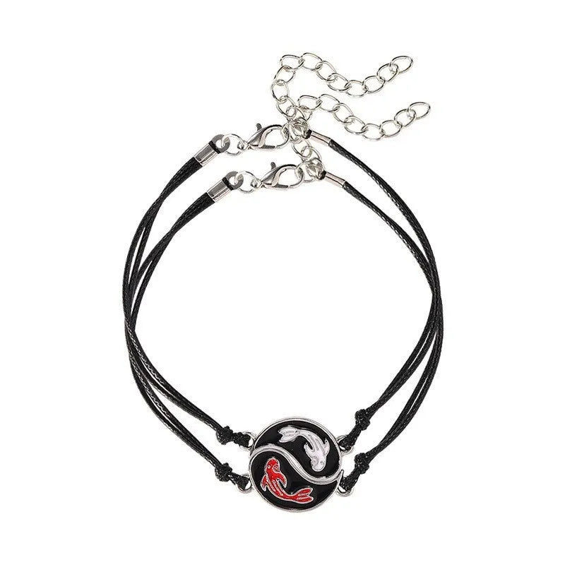 Silver and gold eight-diagram shaped geometric alloy bracelet on a wrist.