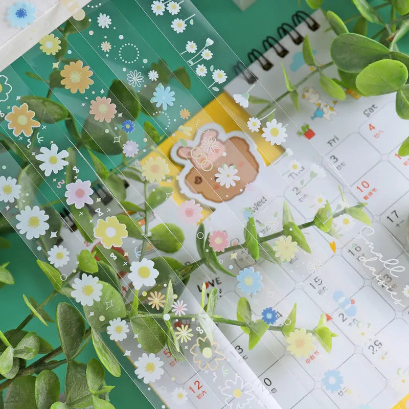 Five rolls of Midsummer Daisy coloured decorative adhesive tape with cartoon design on transparent PET base.
