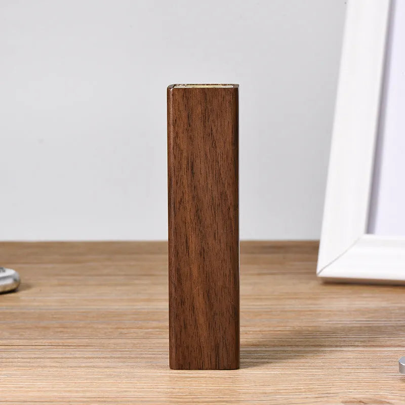 Brown walnut wood portable power bank with dimensions 100mm by 25mm.