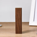 Brown walnut wood portable power bank with dimensions 100mm by 25mm.