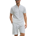 Men's solid colour short sleeve polo shirt and trousers two-piece set on a hanger.