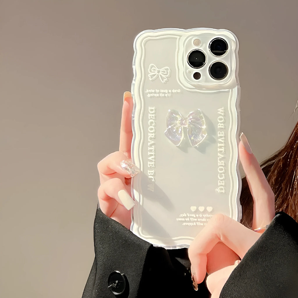 Transparent iPhone case with a three-dimensional ice-through bow decoration on the back.