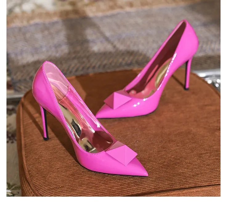 Pink pointed toe stiletto heels for women with patent leather upper and buckle detail