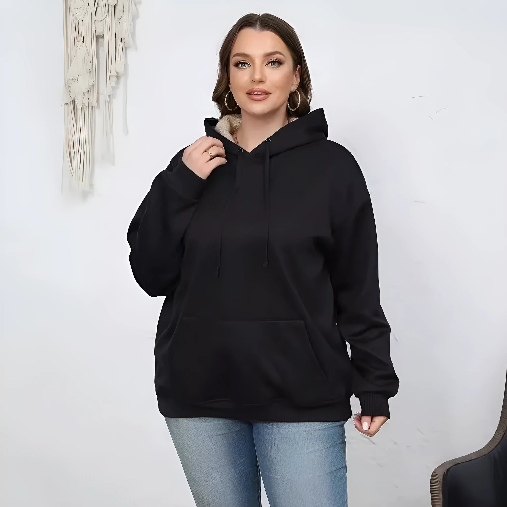 Women's thick grey hooded sweater with a 3D pattern and front pockets on a hanger.