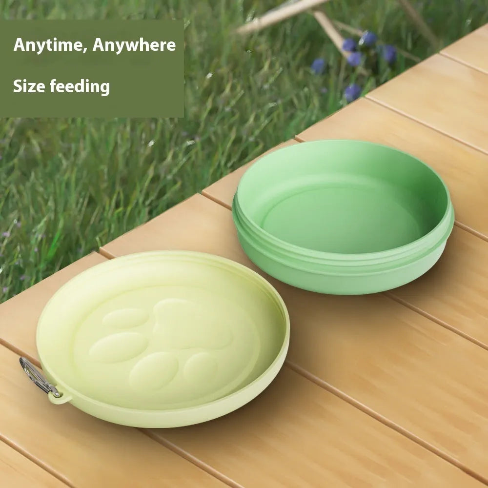 Portable dog feeding bowl with integrated snack box and water compartment, shown in green and pink colour options.