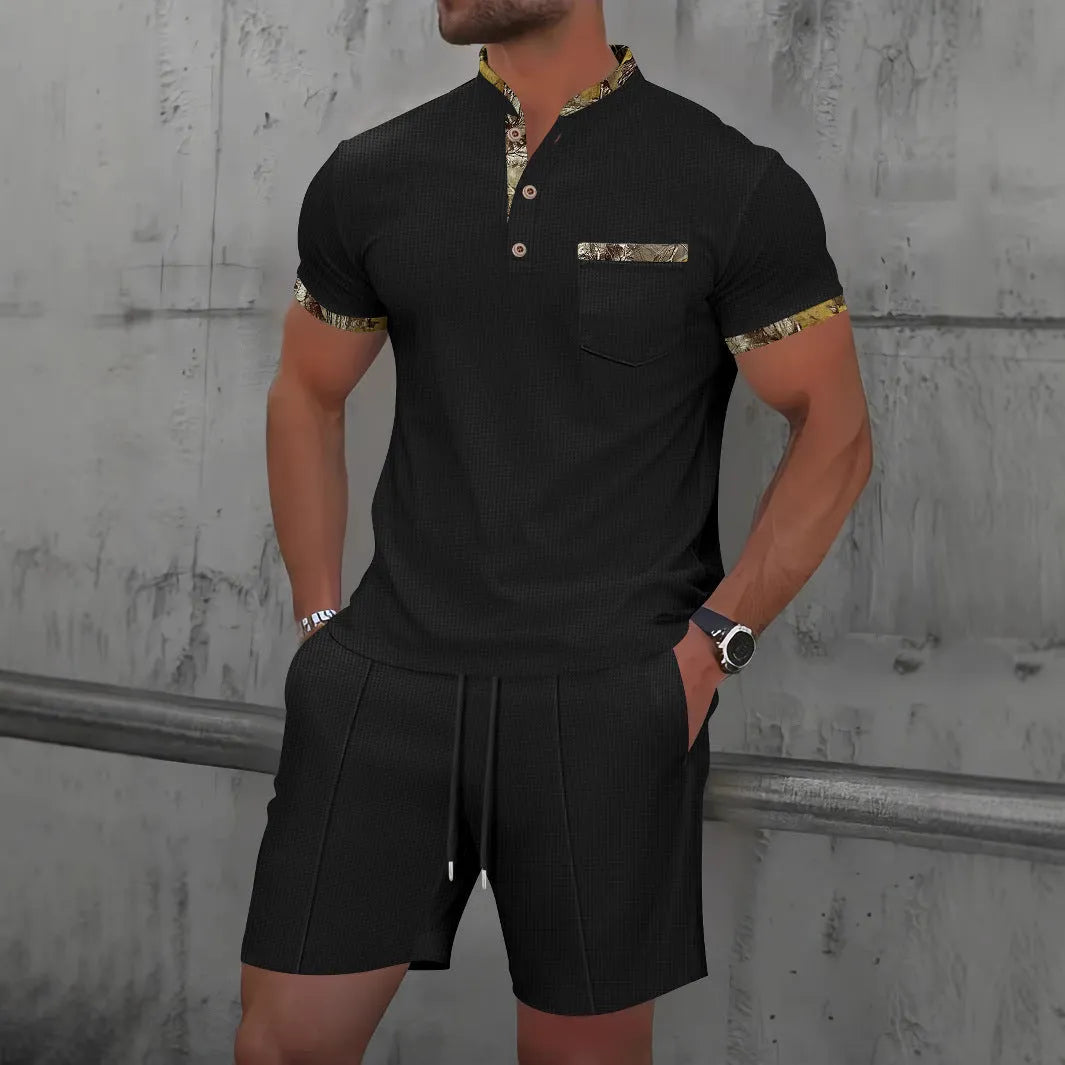 Man wearing a grey zip-front polo collar short sleeve top and matching shorts from a cotton blend suit set.