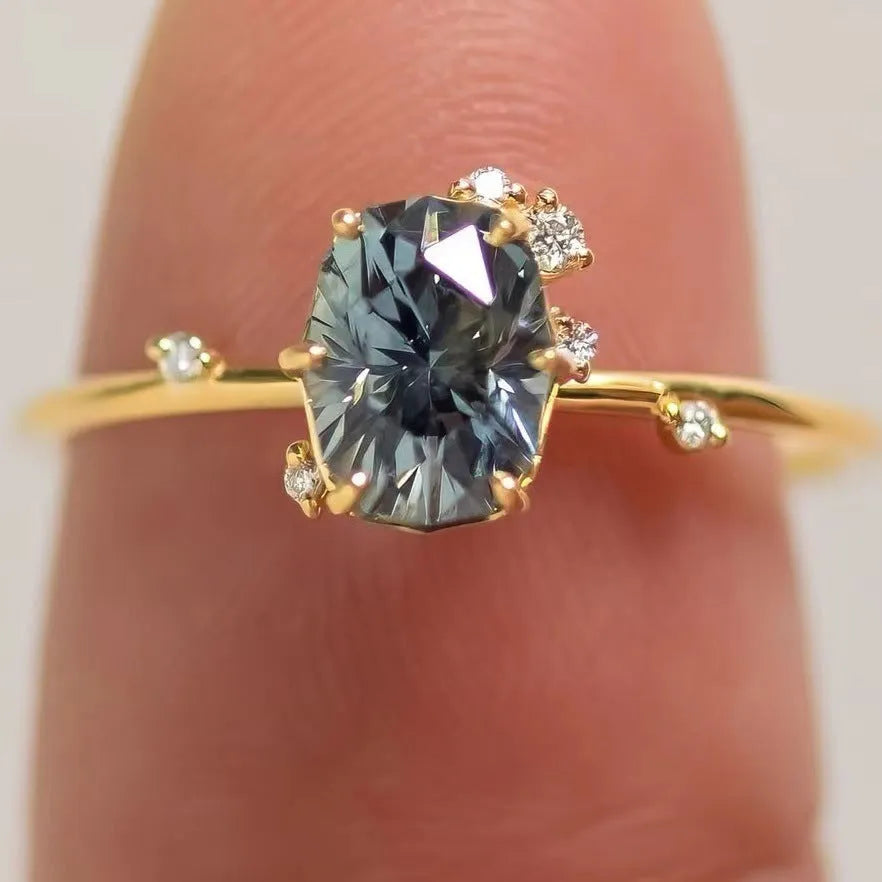 Gold-coloured women's ring with a green zircon stone in a flower-shaped setting.