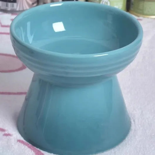 High-foot ceramic pet bowl with chin protector and anti-tumble base design