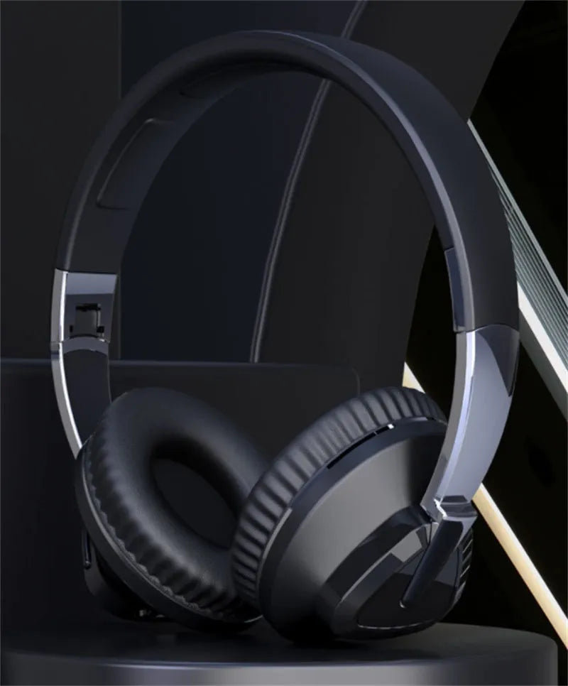 Wireless over-ear headset in black with Bluetooth logo, AUX jack, and TF card slot visible.